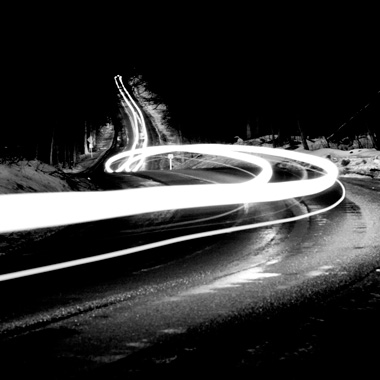 Black and white extended exposure photograph of car light trail in woods in Huntingdon, Pennsylvania